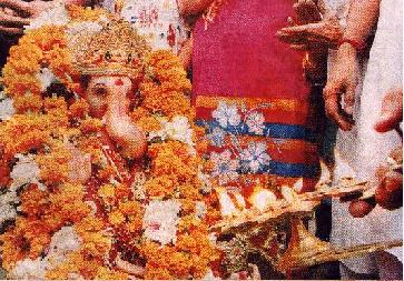 'Aarti' being performed on an idol of the demon Ganapati