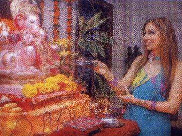 Indian model, Pooja Mishra, performs 'Aarti' on an idol of the demon Ganapati