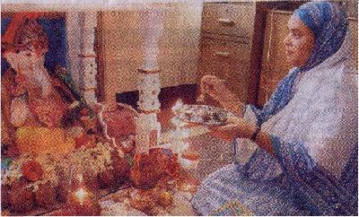 Muslim housewife Shahida Khan performing 'Aarti' upon an idol of the demon Ganapati in her home